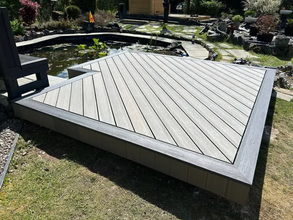 Composite decking with steps to a lower garden level installed by Glasgow Decking Group in Paisley